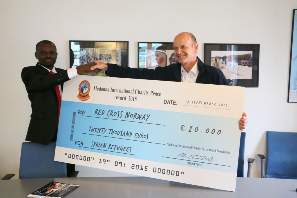 Mr. Martin Anagboso, Director of Public Relations MICPA presenting the award donation to  Mr. Sven Mollekleiv, President of Norwegian Red Cross at Norwegian Red Cross office in Oslo, Norway